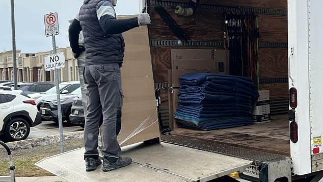 Man unloading items from truck