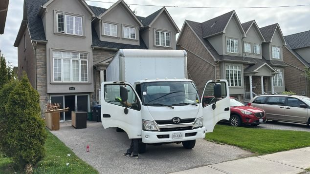 Moving truck parked in residential area