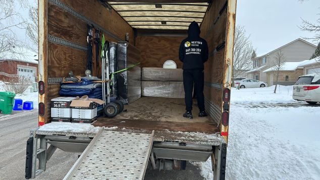Person loading items into moving truck