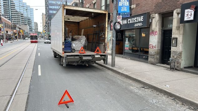 Truck blocking street with warning triangles