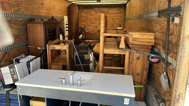 Packed truck with various furniture items