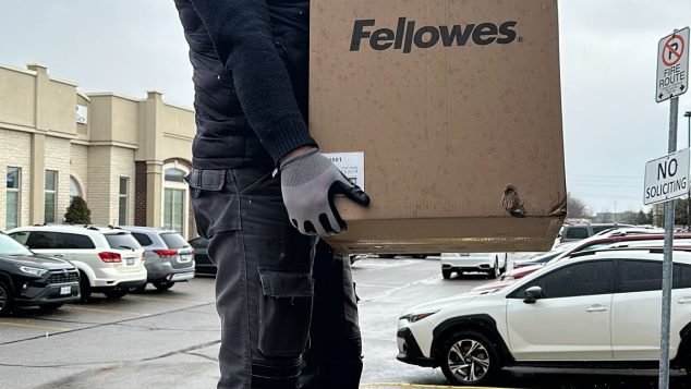 Person holding a large cardboard box.