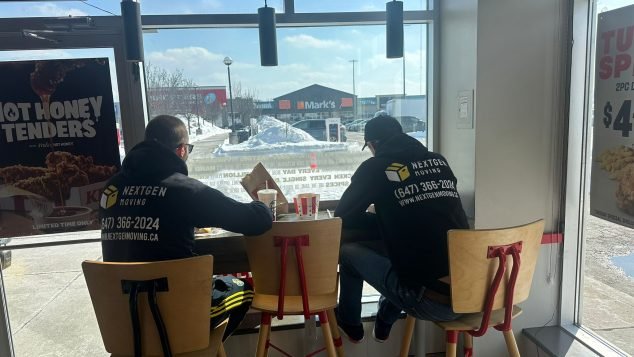 Two people eating in restaurant.