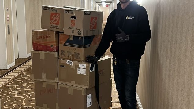 Person pushing cart of boxes