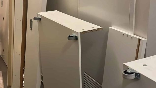 Stacked white panels against a wall