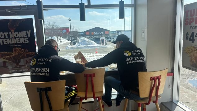 Two men sitting at a window.