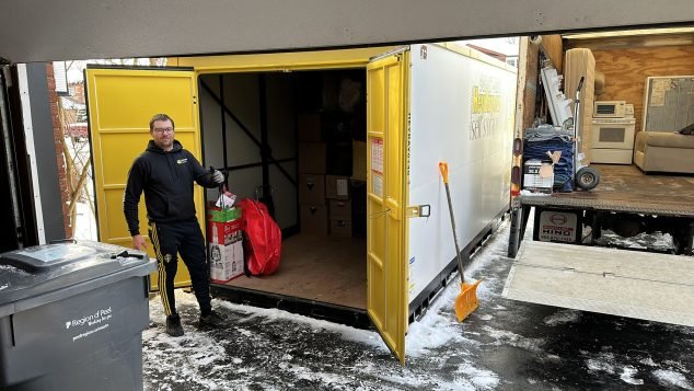 Man unloading items from storage container.