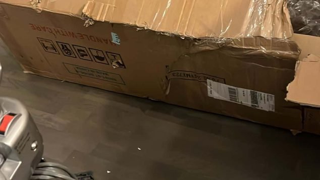 Open cardboard box on floor