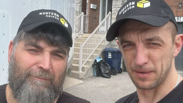 Two individuals in matching black outfits.