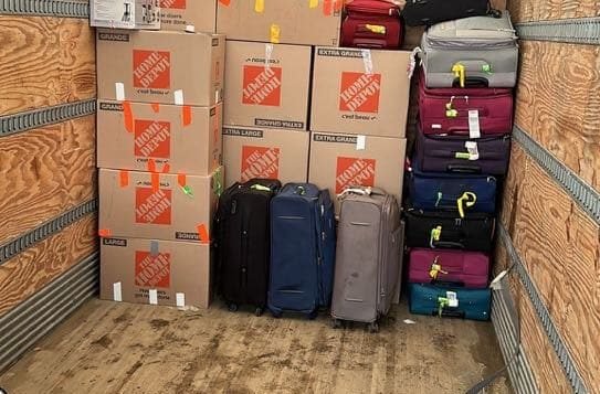 Packed moving truck with luggage and boxes