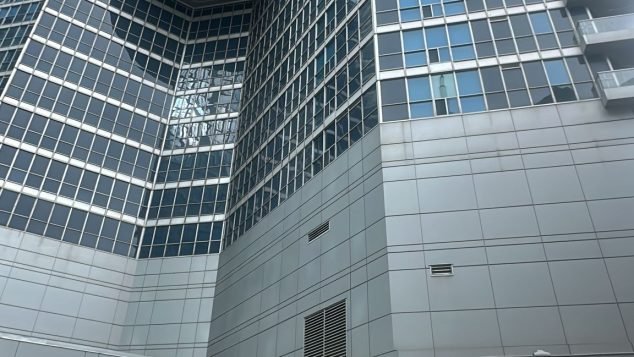 Tall building with delivery truck below.