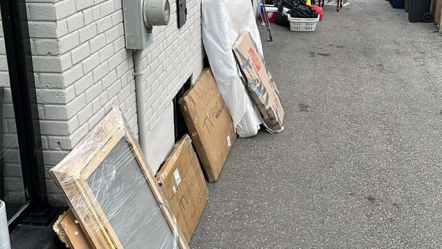 Items stacked against building wall