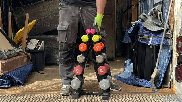 Person holding colorful weights on truck