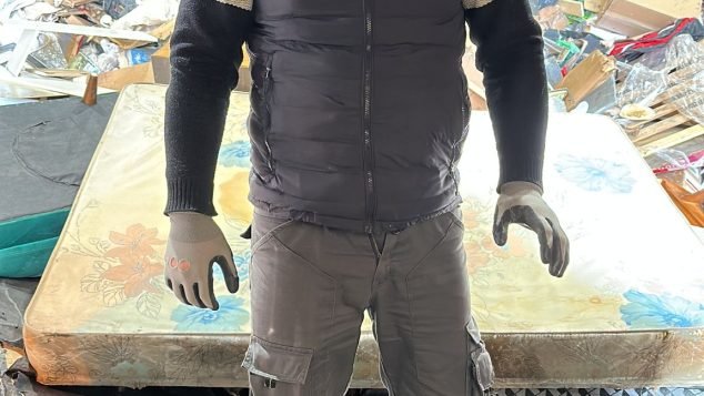 Person standing in a waste facility.