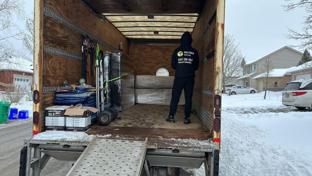 Person loading items into truck