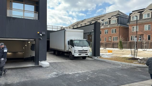Truck exiting a building entrance.