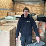 Office movers in North York carefully relocating office furniture and workstations.